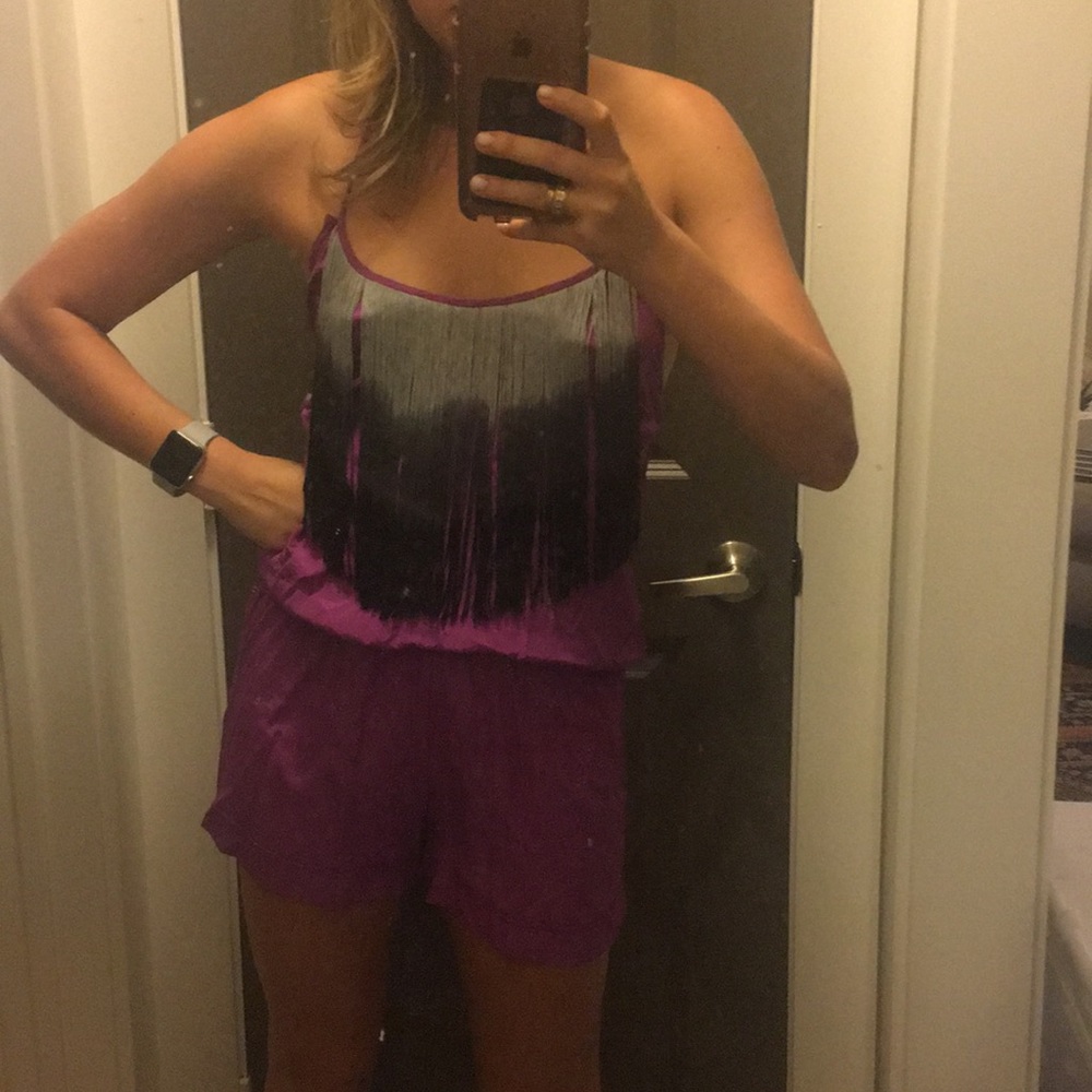 Backless romper with tassels.